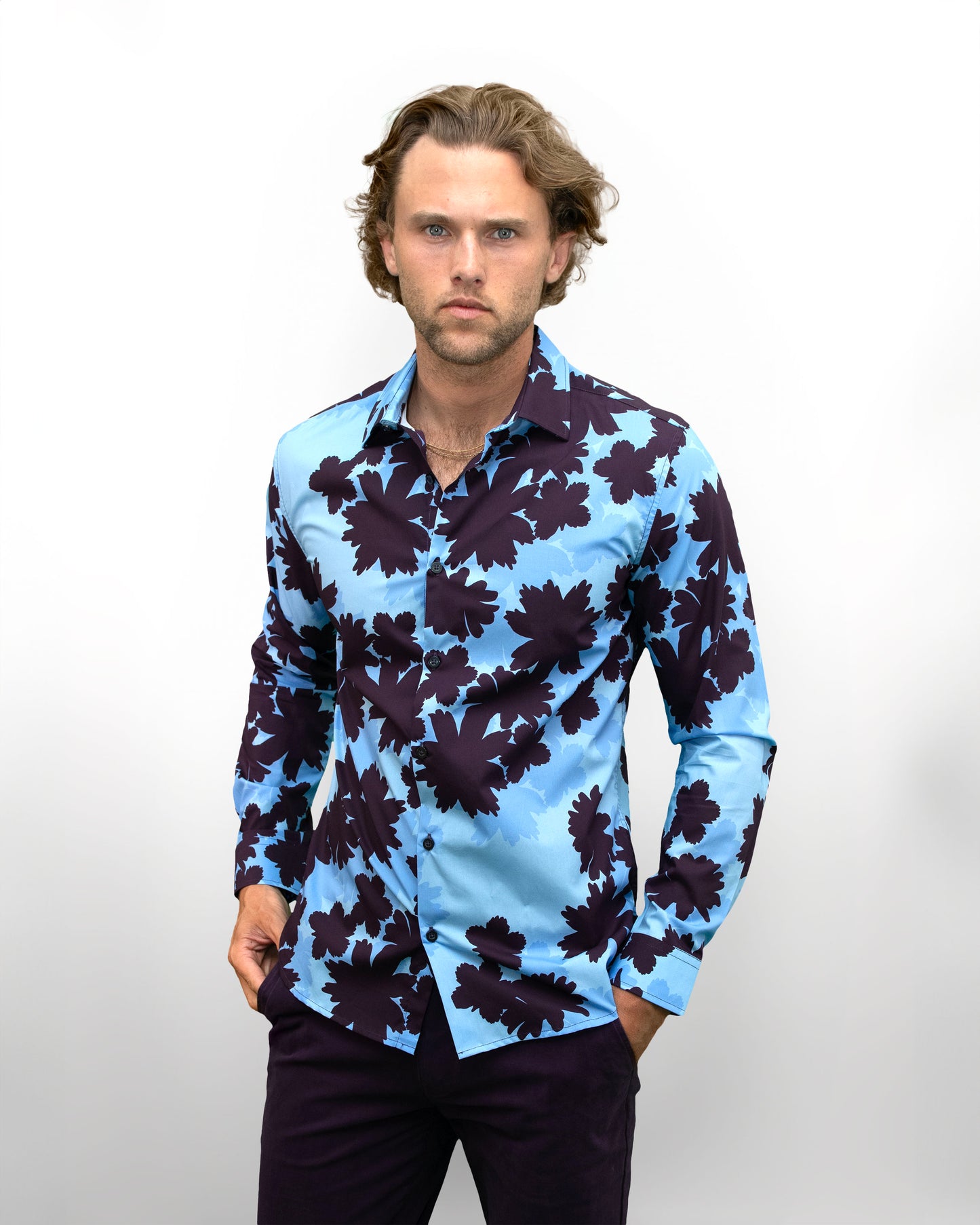 Model wearin a men's blue Norman Salerno floral shirt with bold floral pattern, designer menswear