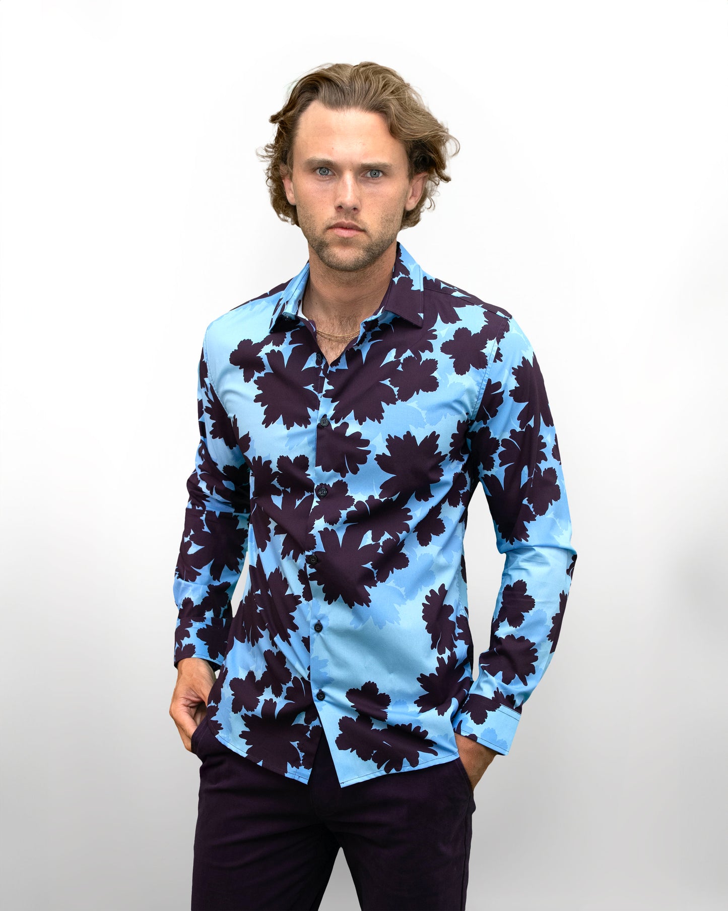 Model wearin  a men's blue Norman Salerno floral shirt with bold floral pattern, designer menswear